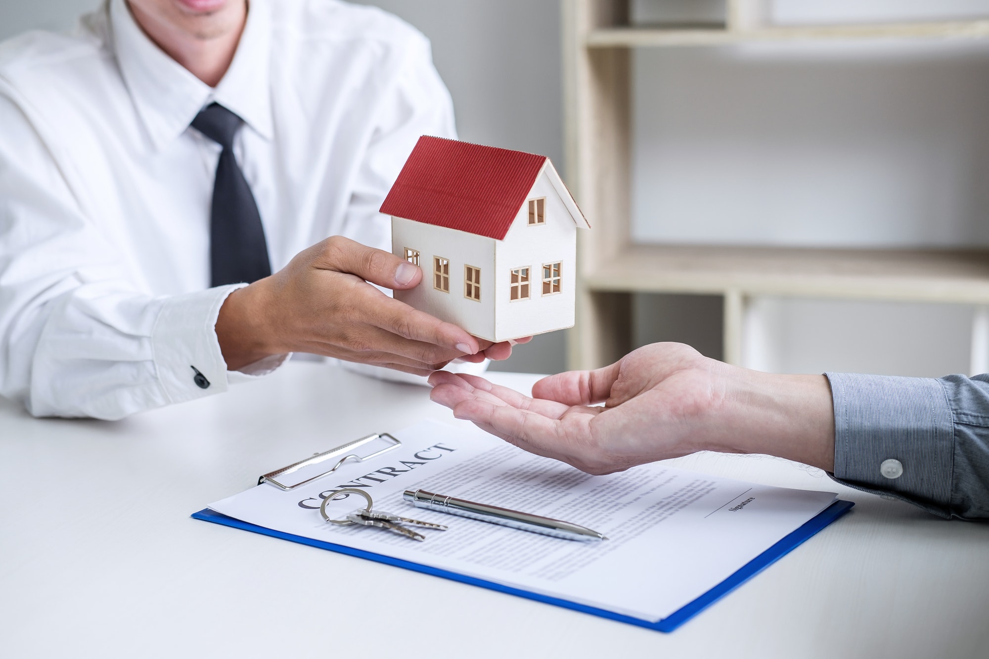 real-estate-broker-agent-presenting-and-consult-to-customer-to-decision-making-sign-insurance-form-1.jpg